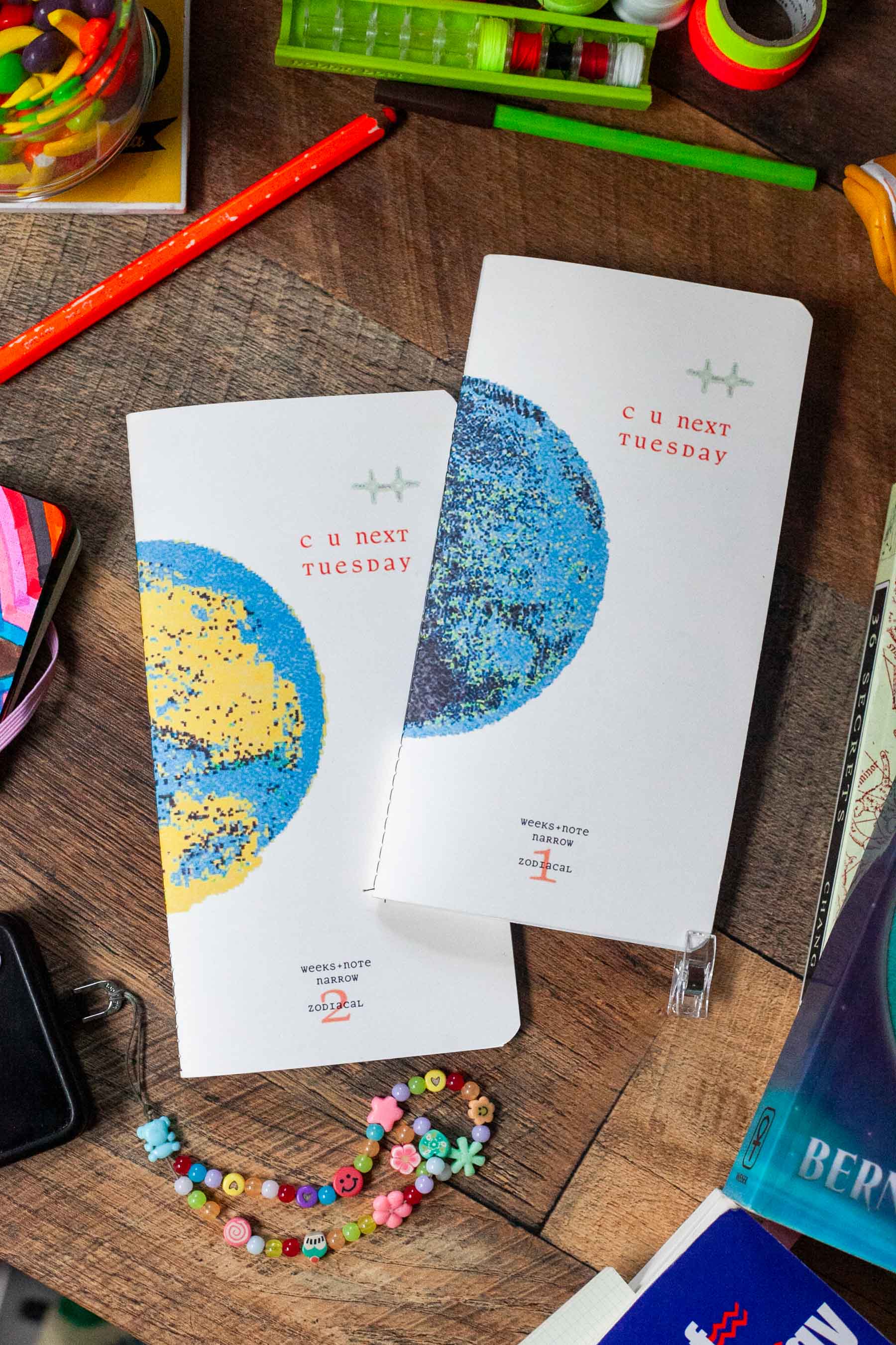 c u next tuesday zodiacal planners on table